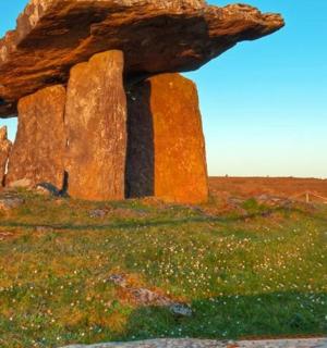 a large rock sitting on top of a field