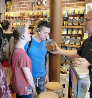 muž stojící v obchodě se skupinou lidí