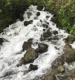 a stream of water rushing over rocks in a river