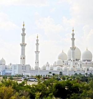 a mosque with white domes and minarets