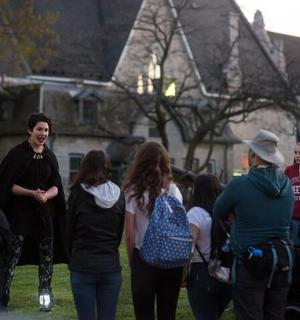 a group of people standing around in the grass