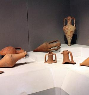 a group of pottery on display in a museum