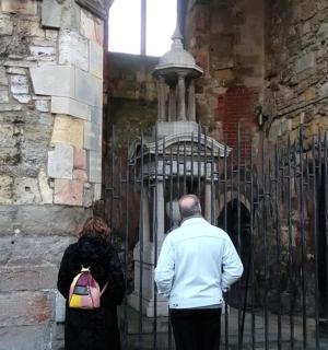 a man and a woman standing in front of a gate