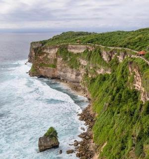 an aerial view of the ocean and a rocky coastline
