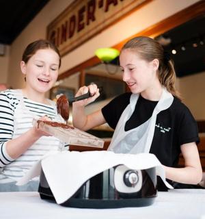 两个女孩坐在桌边吃饭