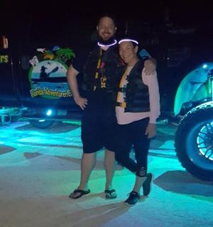 a man and a woman standing in front of a truck