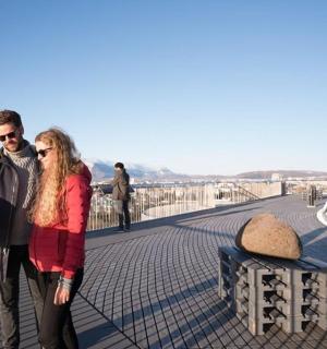 a man and a woman standing on a bridge