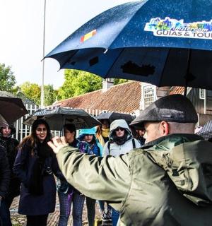 a man taking a picture of a group of people with umbrellas