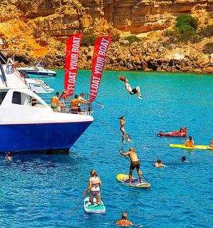 a group of people in the water near a boat