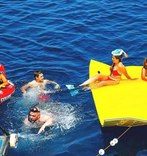 a group of people in the water on boats