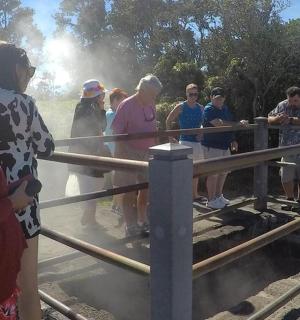 a group of people standing near a fence