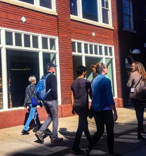 a group of people walking down a street