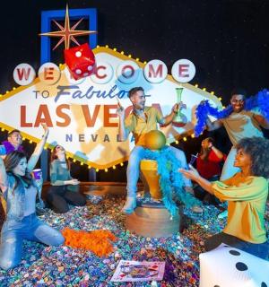 a group of people standing around a birthday cake