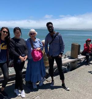 a group of people standing next to the ocean