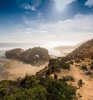 a view of a beach with rocks and the ocean