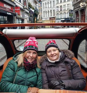 two women are sitting on a trolley