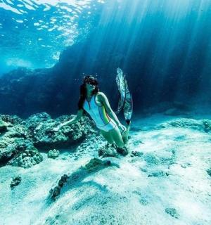 a woman standing in the water in the ocean