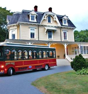 a trolley bus parked in front of a house