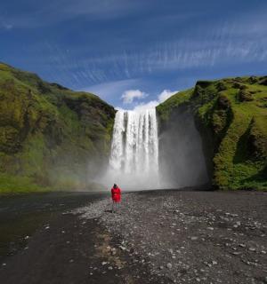 a person standing in front of a waterfall