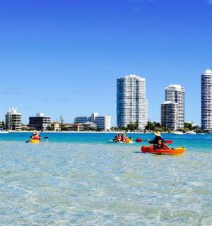 a group of people riding on kayaks in the water