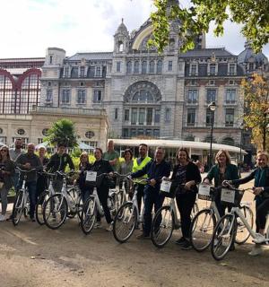 a group of people on bikes in front of a building