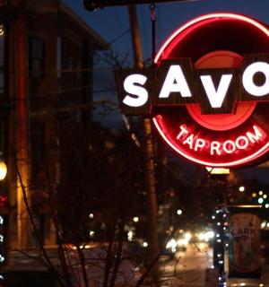 a neon sign for a yawnarmaarma restaurant on a street