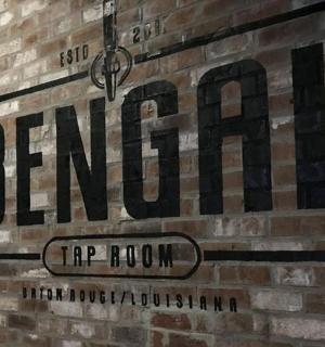 a sign on the side of a brick wall