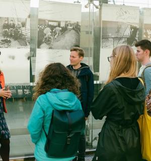 a group of people standing in front of a display case
