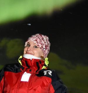 a woman wearing a red jacket and a hat