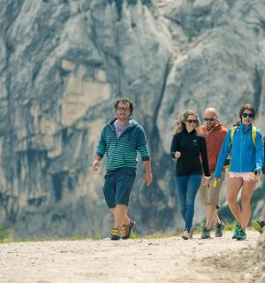 skupina lidí jdoucích po prašné cestě