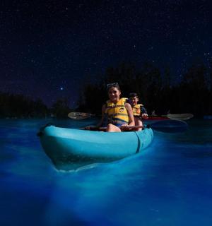 two children are riding on a raft in the water