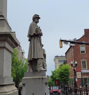 socha muže stojícího na ulici