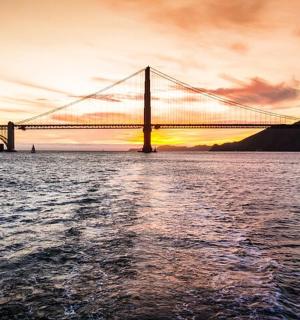 a bridge over a body of water at sunset