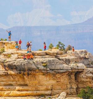 a group of people standing on top of a mountain