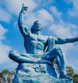 a statue of a man sitting on a rock