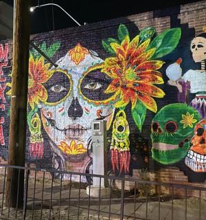 a mural on the side of a building with skulls