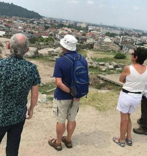 a group of people standing on top of a hill