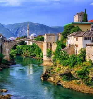 an old bridge over a river in a town