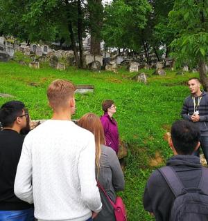 a group of people standing around in a cemetery