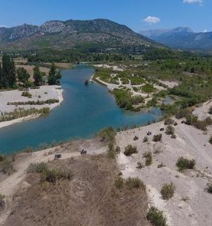an aerial view of a river with mountains in the background