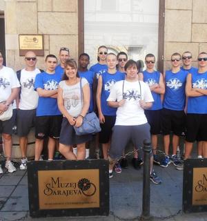 a group of people posing for a picture in front of a building