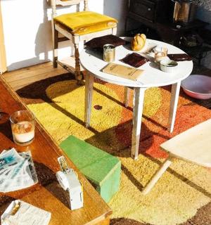 a living room with a table and a white table and chair