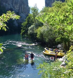 一群人站在河里，船上