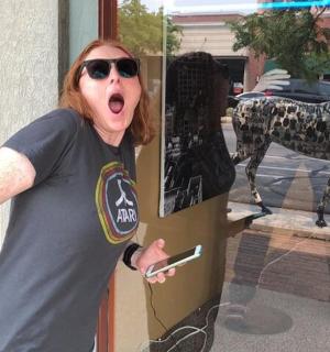 a woman standing in front of a window with her mouth open