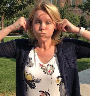 a woman with her hands on her head