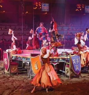 a group of people standing around a table in a circus