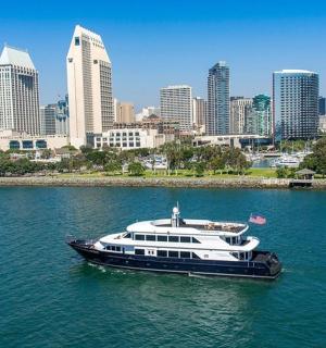 a boat in the water in front of a city
