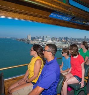 a group of people sitting on a boat on the water