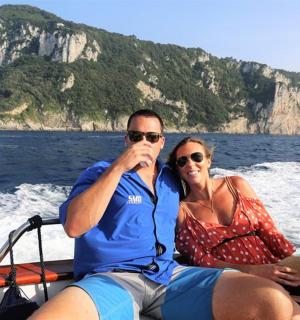 a man and woman on a boat in the water