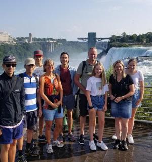 skupina lidí stojící před vodopádem